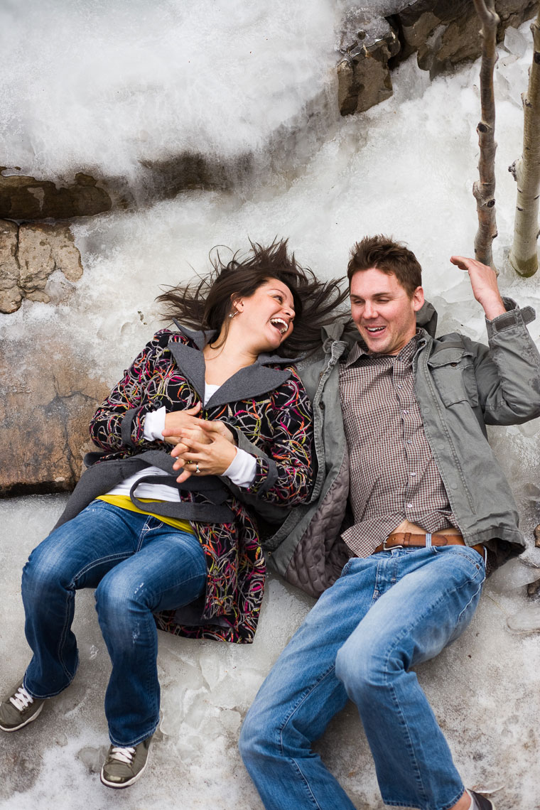 Couple lays on  ice at the El Monte Sagrado Resort in Taos for an enagement photo