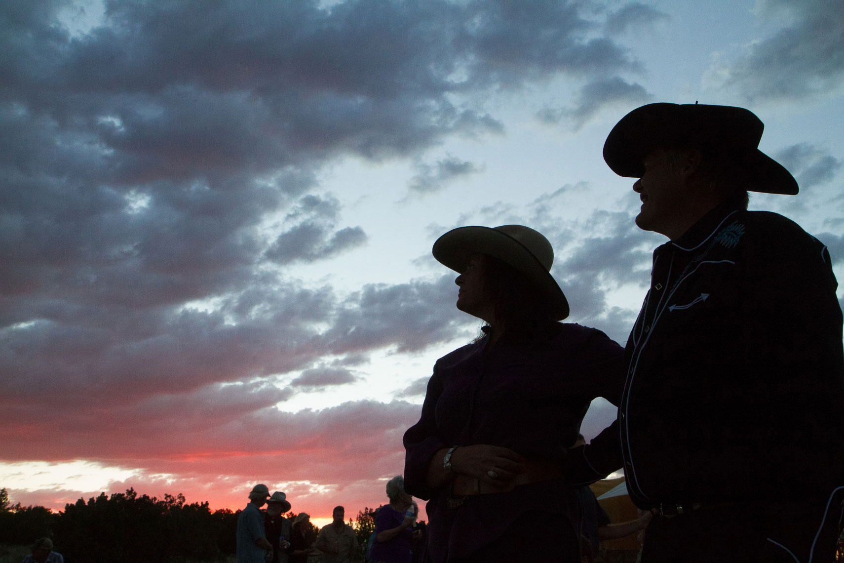 Cowboy hats and wedding couple, sunset on the ranch